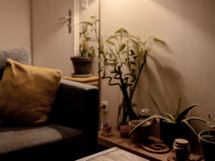 A warm living room in the evening, lit by a single lamp.